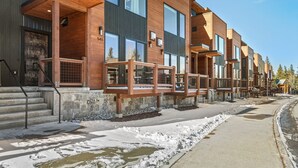 A modern building with large windows and wooden balconies. - Charming 3BR Mountain Retreat in Silverthorne, CO (Silverthorne)