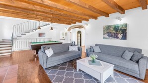 A spacious living area with a pool table, two grey sofas, a white coffee table, and a staircase leading to an upper level. - Enchanting Villa Marijanin Vrt with swimming pool (Tinjan)