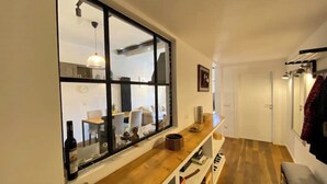 A modern kitchen with a large window, wooden countertops, and a built-in oven.