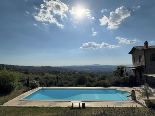 Villa and pool, next to typical Tuscan vineyards and olive groves, breathtaking sunsets