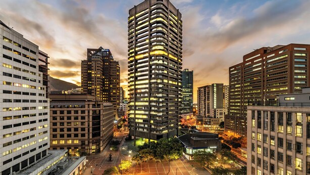 A high-rise building with a modern architectural design, surrounded by other buildings in an urban setting. - Central Light and Bright Studio, No Loadshedding (Cape Town)