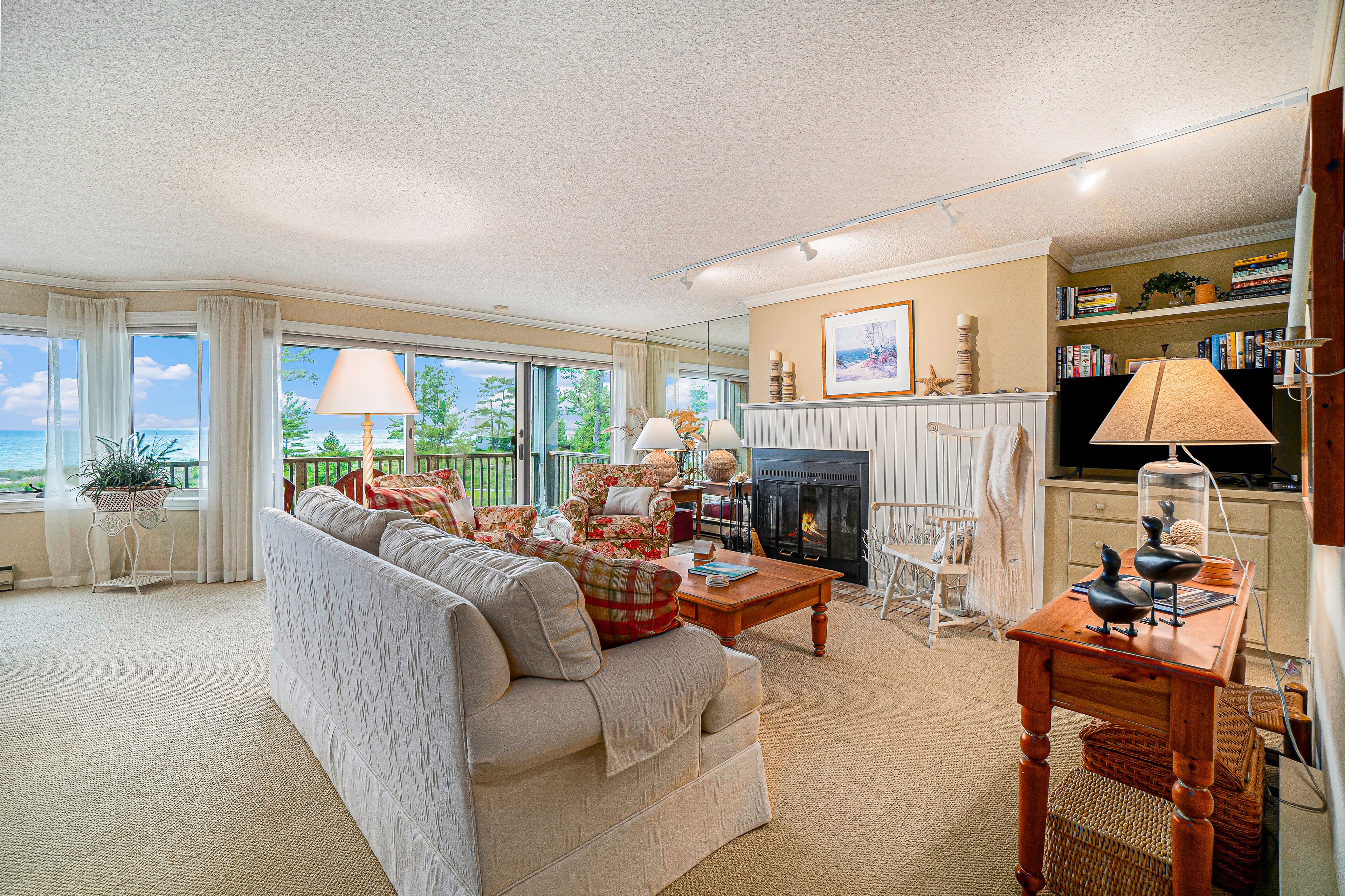 Lake-view condo with private beach, fireplace, deck, washer/dryer, streaming