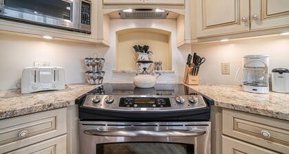 Lake-view condo with private beach, fireplace, deck, washer/dryer, streaming