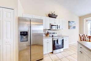 Fridge, microwave, oven, stovetop - Waterfront home with screened pool, patio, grill, foosball, AC, & W/D (Cape Coral)