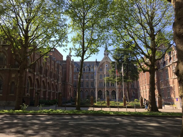 A historic building with arched windows and a prominent tower.