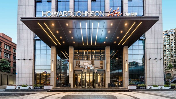 The Howard Johnson Hotel entrance with a modern design, large glass windows, and a prominent sign. - Howard Johnson Life Hotel by Wyndham Chongqing Liangjiang (Chongqing)