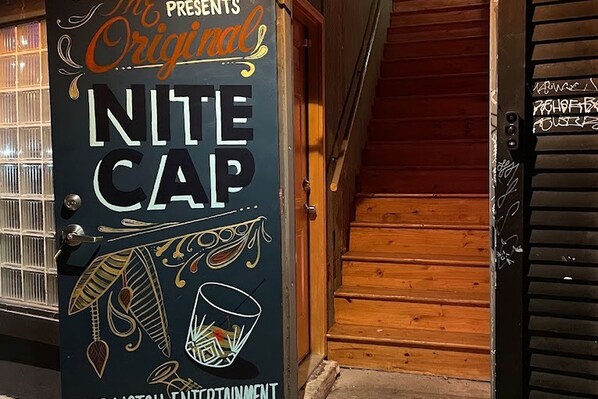 A door with the text 'NITE CAP' and 'Original Entertainment' indicating a venue or establishment.