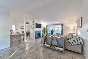 Relax in a cozy space with a fireplace, dining area, and comfortable seating, perfect for socializing or unwinding.