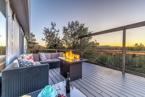 Relax on the outdoor deck with a fire feature and take in the serene views of the surrounding landscape.