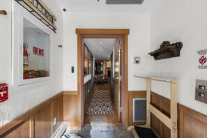 A hotel hallway with a fire hose sign, a fire alarm, and a stairwell sign. - 2 King Suites • Walk to Gondola & Base • Pool & Hot Tub • Spacious 1848 sq ft (Steamboat Springs)