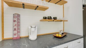 A kitchen with wooden shelves, a coffee maker, and a decorative sign. - Northport Game Day Getaway: 5 Mi to University! (Northport)