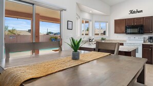 A modern kitchen with wooden cabinets, a microwave, and a stove. - STOCKED Pool Home, RV & Boat parking, Game room. Sleeps 13 (Lake Havasu City)
