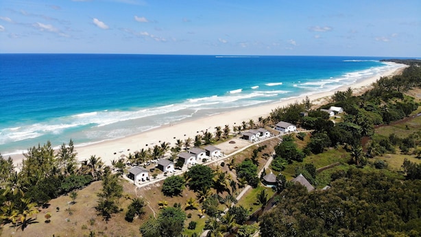 A coastal resort with beachfront villas, a sandy beach, and lush greenery. - Comfort Villa with Sea View (Sainte-Marie)