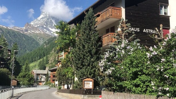 A hotel named "HAUS ASTRAL" with a view of snow-capped mountains in the background. - Studio Marmotta - Zermatt (Zermatt)
