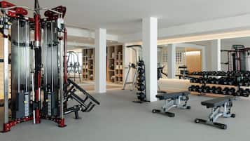 A gym with various exercise equipment, including weight machines and dumbbells.