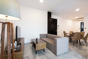 Relax in a stylish room with a comfortable sofa, flat-screen TV, and dining area.