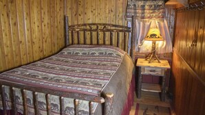 A wooden room with a bed, a nightstand, and a lamp. - Pine Lake Trout Club Cabin #4!!! (Chagrin Falls)