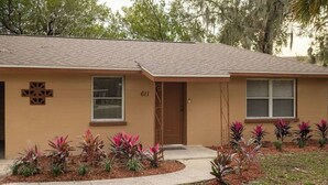 A single-story building with a beige exterior, a brown roof, and a number '611' on the front. - Comfort Living Near LRMC, Medical Row
 (Lakeland)