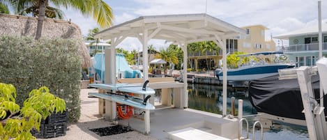 Fish cleaning area with freshwater hoses. 2 paddle boards for guests to use.
