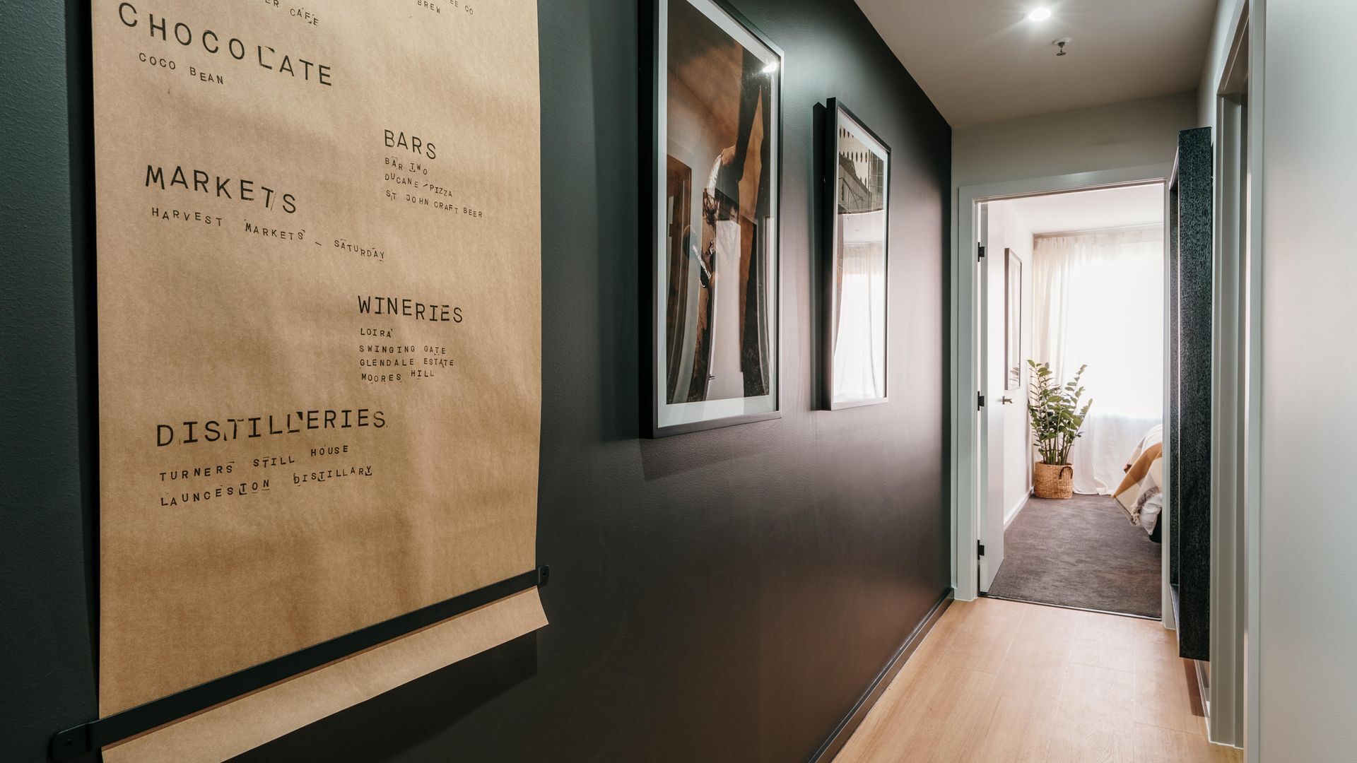 A hallway with a corkboard displaying local attractions and businesses.
