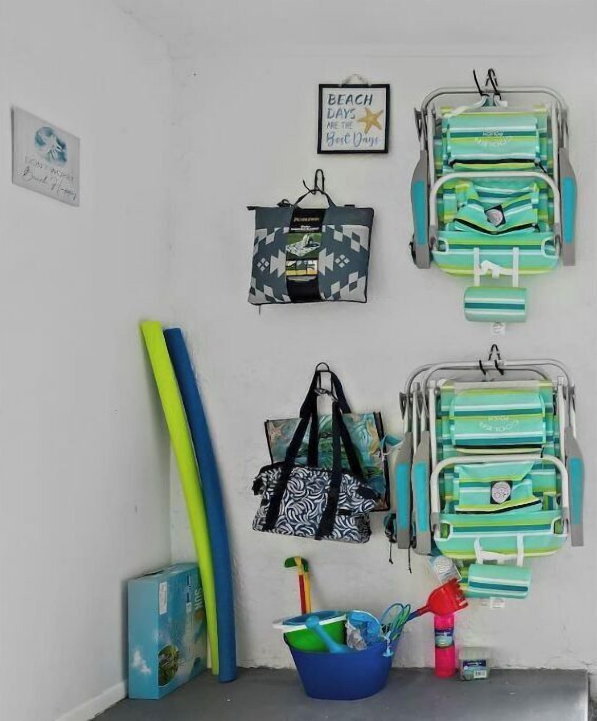 A wall with various bags and a surfboard, a bucket with cleaning supplies, and a sign that says "BEACH DAYS ARE THE BEST DAYS".