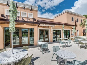 Relax in the outdoor seating area with a clear view of the Market Coffee Shop facade.