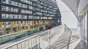 A modern building with multiple floors, large windows, and a glass facade.