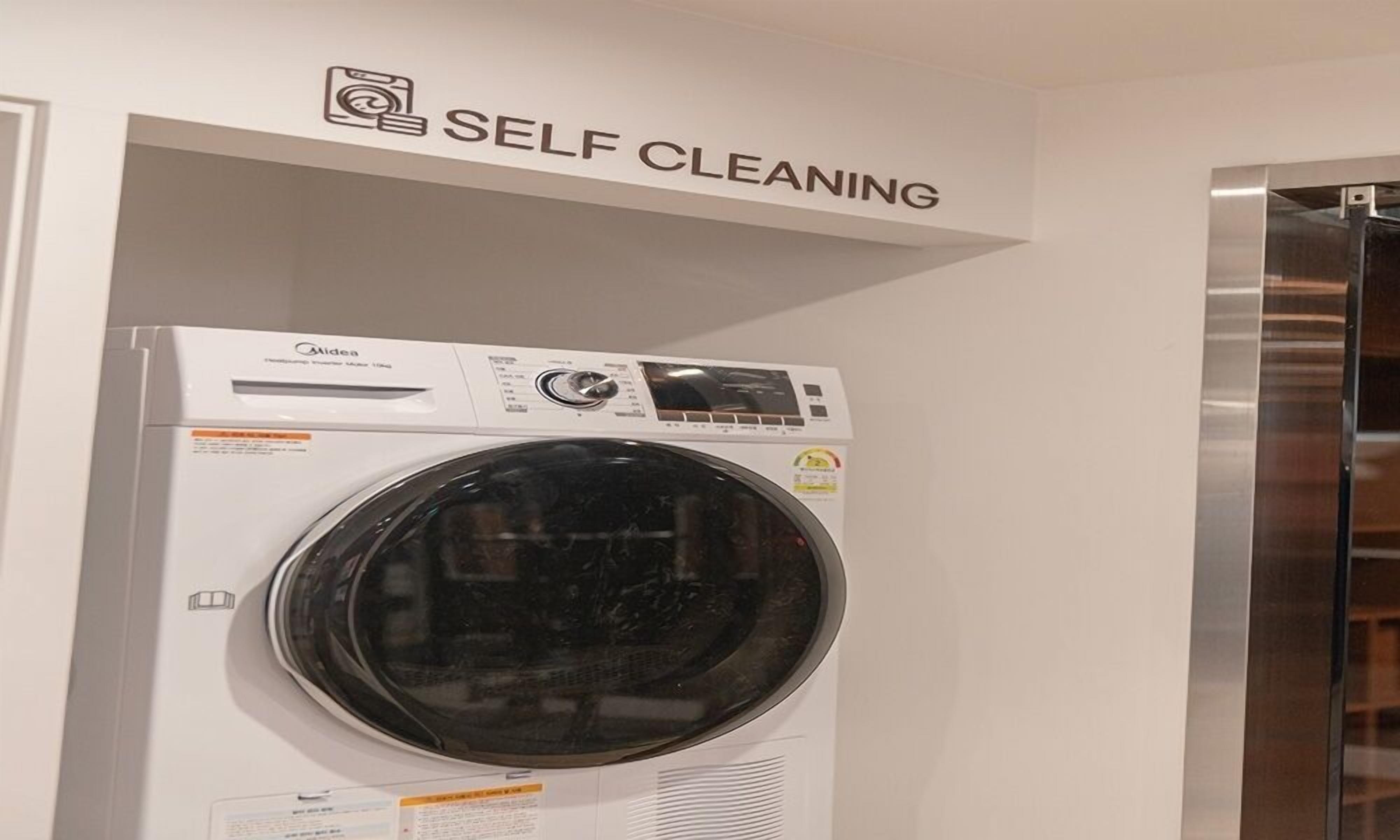 A self-cleaning washing machine with a control panel and a large circular drum.