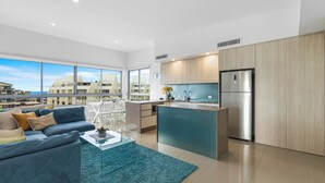 A modern apartment with a living area, kitchen, and dining space. - Nova Ocean Views Mooloolaba 2 Bedroom Apartment (Sunshine Coast)