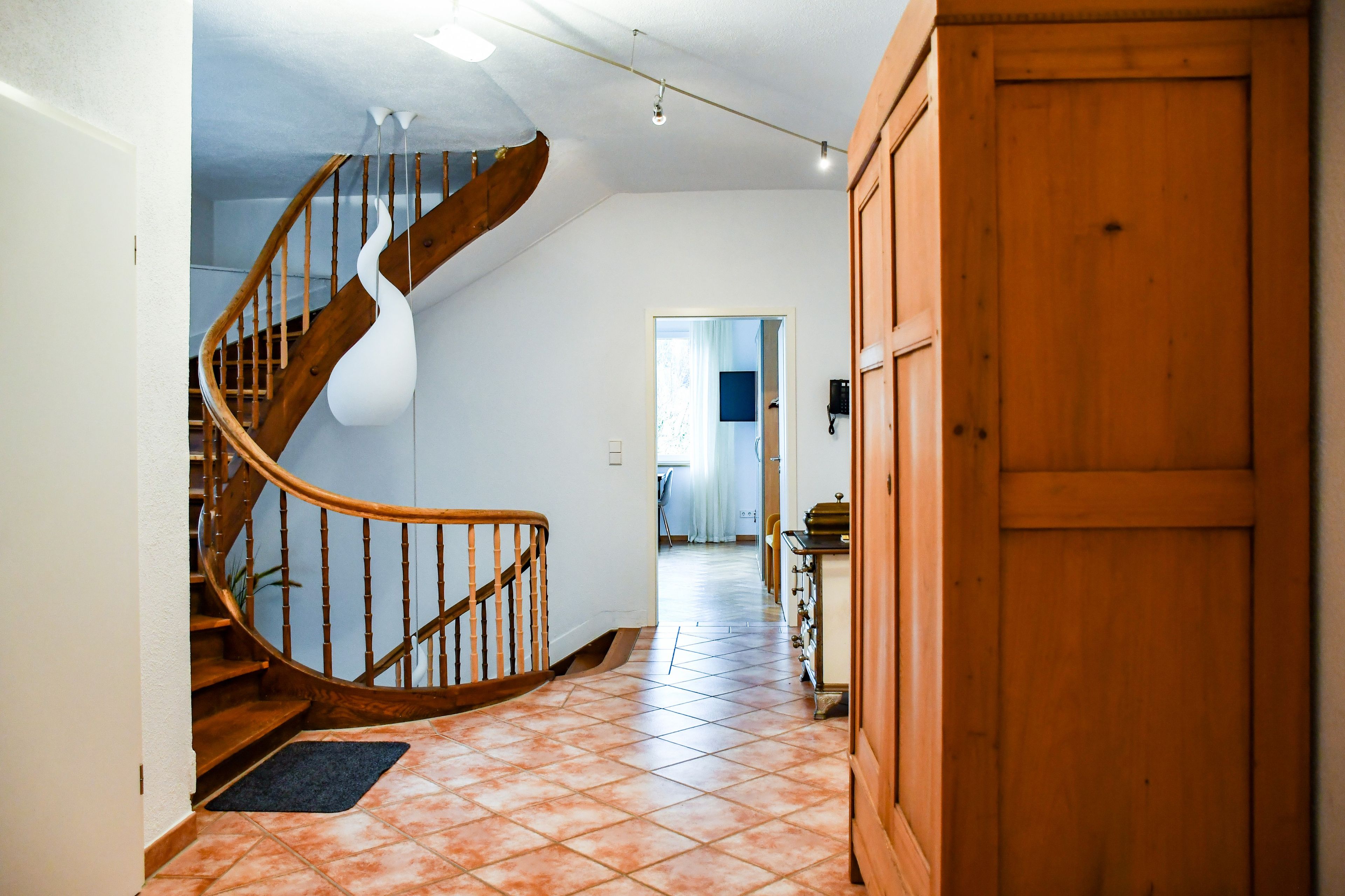 A staircase with wooden railings leading to a landing.