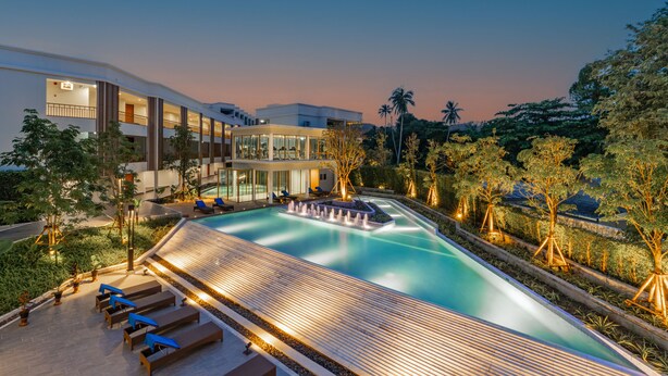 A modern hotel with a swimming pool, lounge areas, and a landscaped garden. - Bella Nara Phuket Naiyang Beach (Sa Khu)