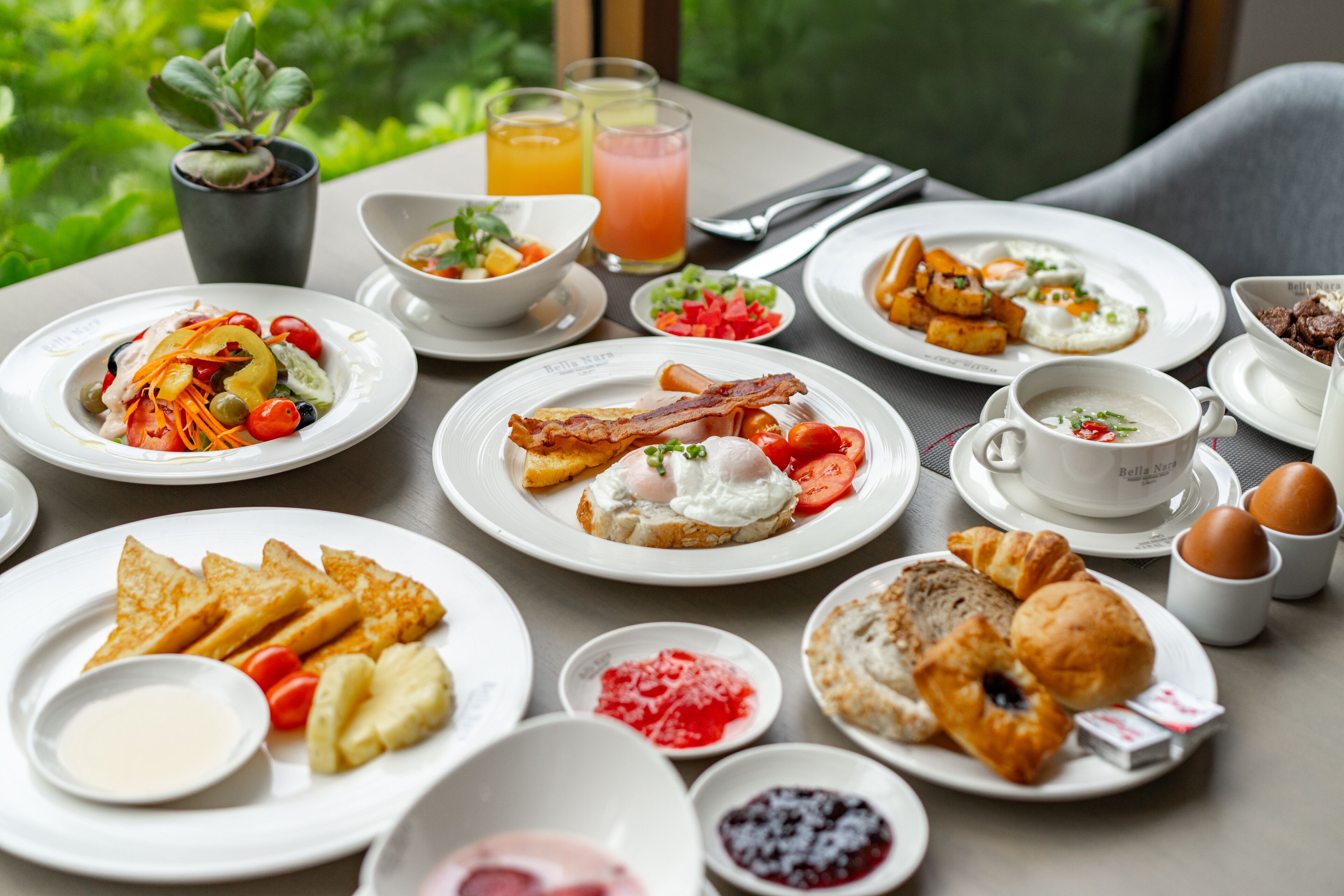 A table set with breakfast items including eggs, toast, and fruit.