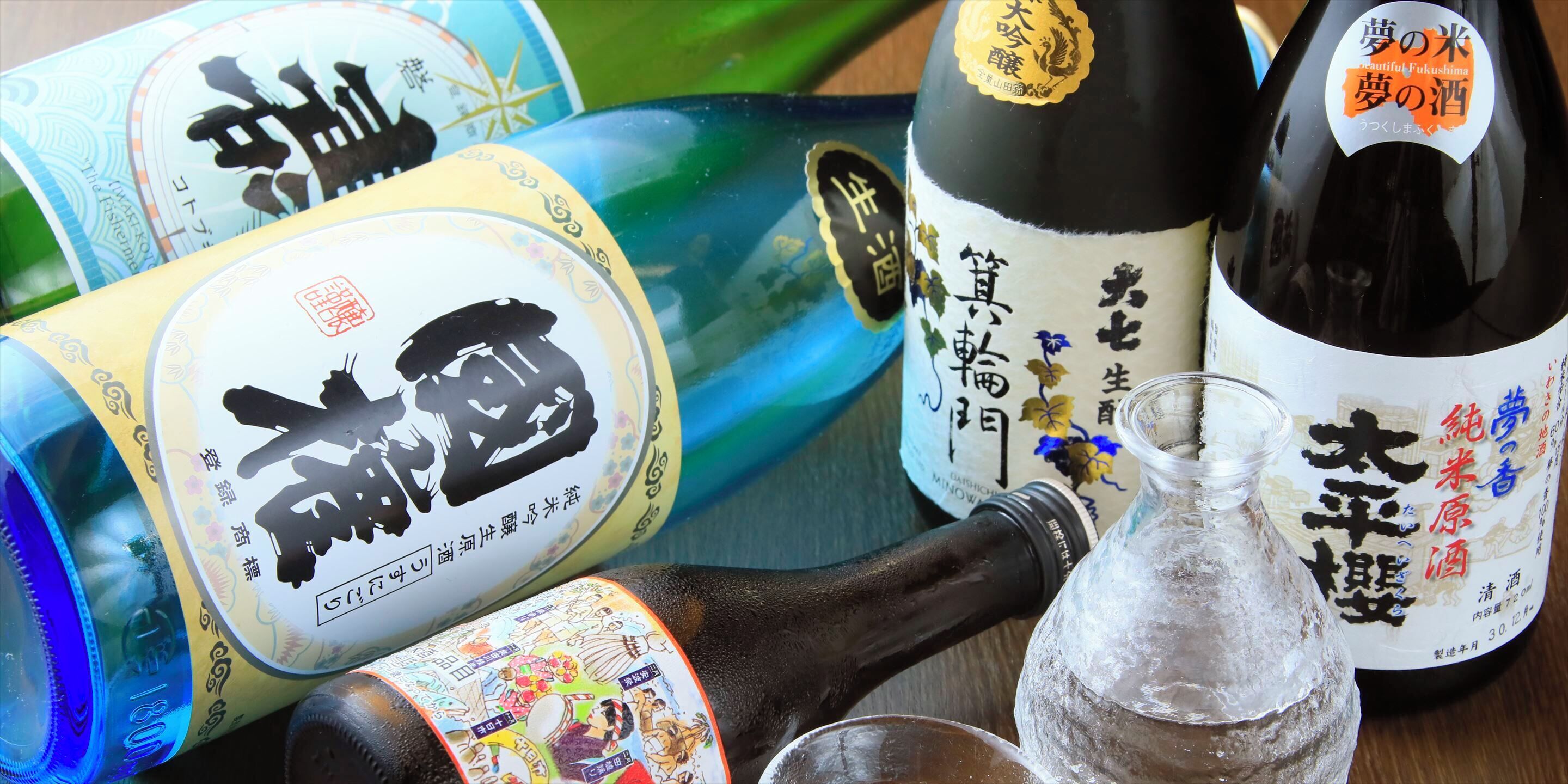 A variety of bottles with labels, a glass jar, and a bottle with a cork.
