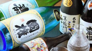 A variety of bottles with labels, a glass jar, and a bottle with a cork.
