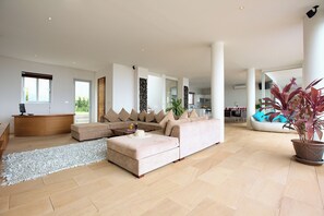 A spacious living room with a large sectional sofa, a coffee table, and a potted plant. - Luxury 7BR Seaview Villa with Private 18M Infinity pool &Panoramic Views (Koh Samui)
