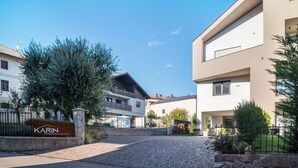 Ein modernes Gebäude mit einem Schild, auf dem 'Karin Ferienwohnungen' steht.