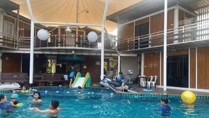 A swimming pool area with a slide and inflatable toys. - Hi Creek Resort  (Si Bun Rueang)