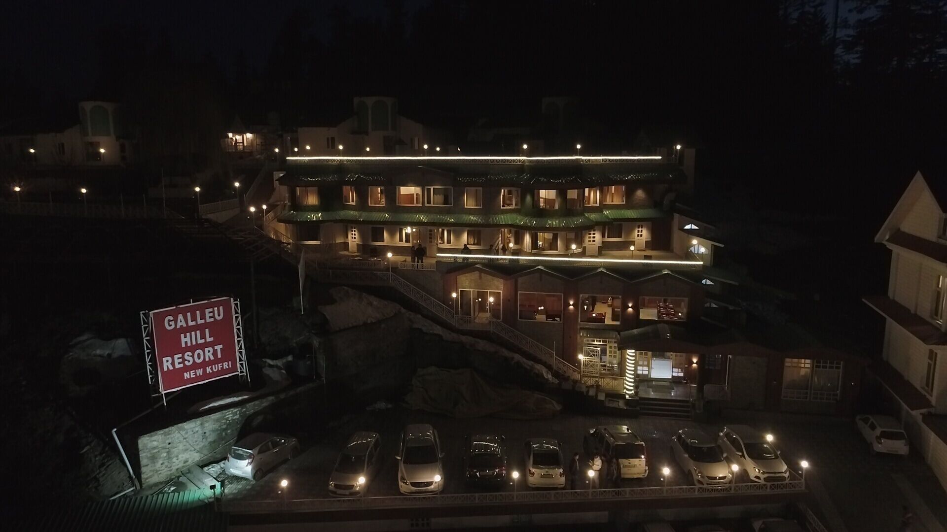 A multi-story hotel with a sign for 'Galleu Hill Resort'.