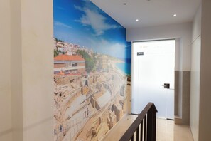 A hallway with a mural of an ancient amphitheater and a modern cityscape. - Colonia Iulia Urbs Triumphalis (Tarragona)