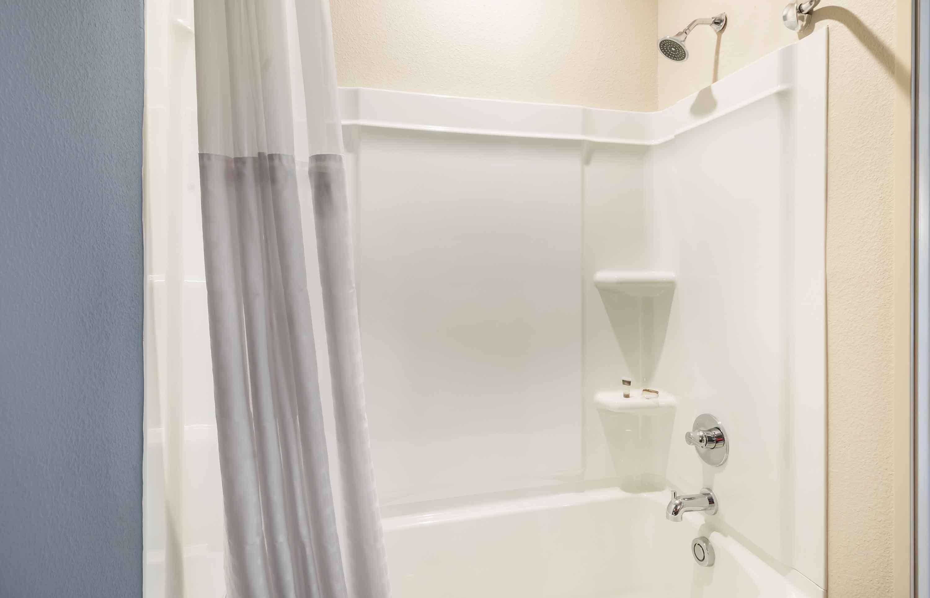 A bathroom with a bathtub, a shower, and a toilet.