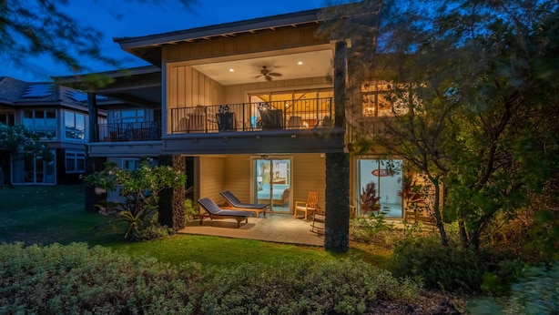 A two-story house with a balcony, outdoor seating area, and a well-maintained garden. - Luxury + Privacy ✨ Near Putting Green ⛳ Beach Club Access 🏖️ (Waimea)