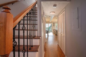 A wooden staircase with ornate balusters leading to a landing. - Ocean Dunes 1401 (Kure Beach)