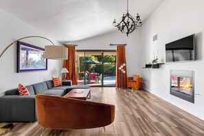 Relax in this stylish living room with a sofa, armchair, and fireplace, perfect for unwinding.