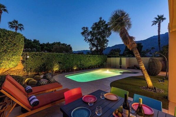 Relax by the serene pool surrounded by lush landscaping and comfortable seating.