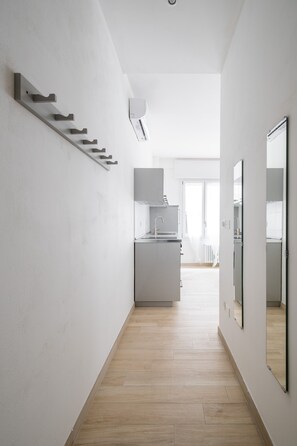 A modern kitchen with a built-in oven and a large window.