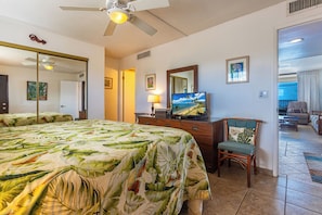A hotel room with a bed, a television, a desk, and a chair. - Kihei Beach #507: Your Front-Row Seat to Paradise (Kihei, Maui)