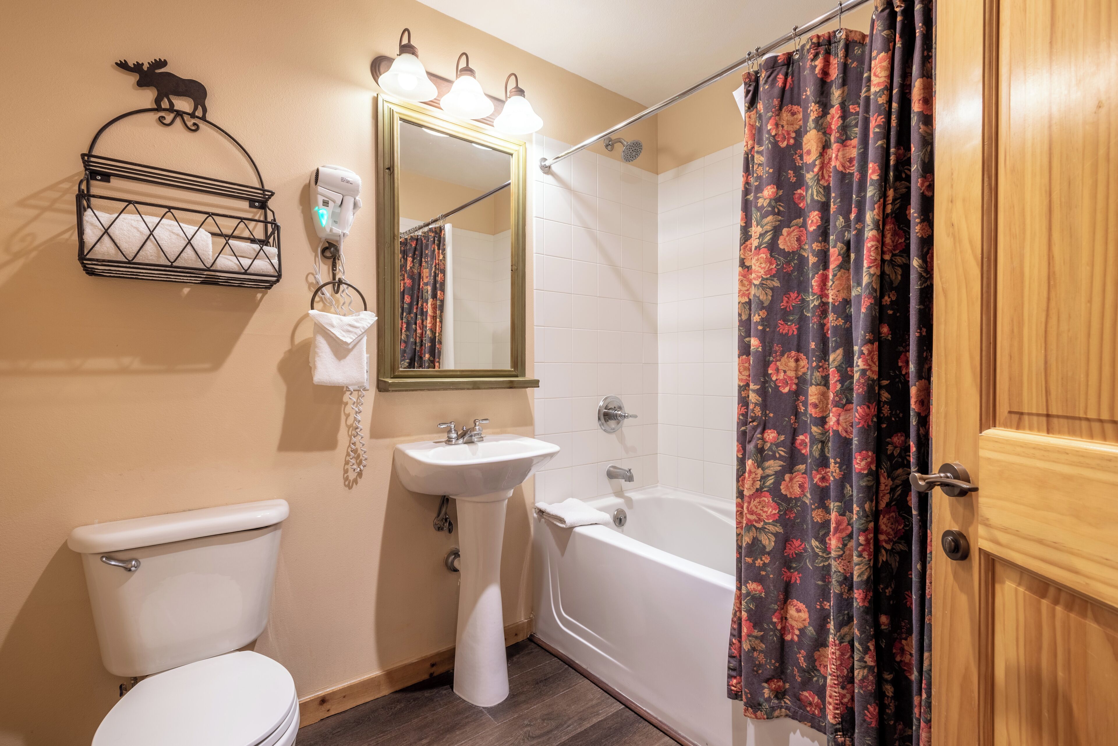 A bathroom with a toilet, sink, and bathtub.