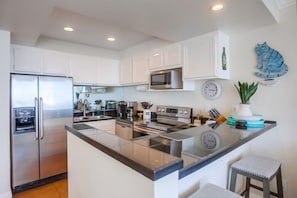 Enjoy cooking in this well-lit kitchen with a large island and modern appliances.