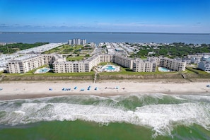 Een kusthotel met meerdere gebouwen, een strand en een zwembad.
