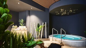 A modern spa area with a hot tub, lounge chairs, and a variety of plants. - [PLACES] Obertauern by Valamar (Untertauern)
